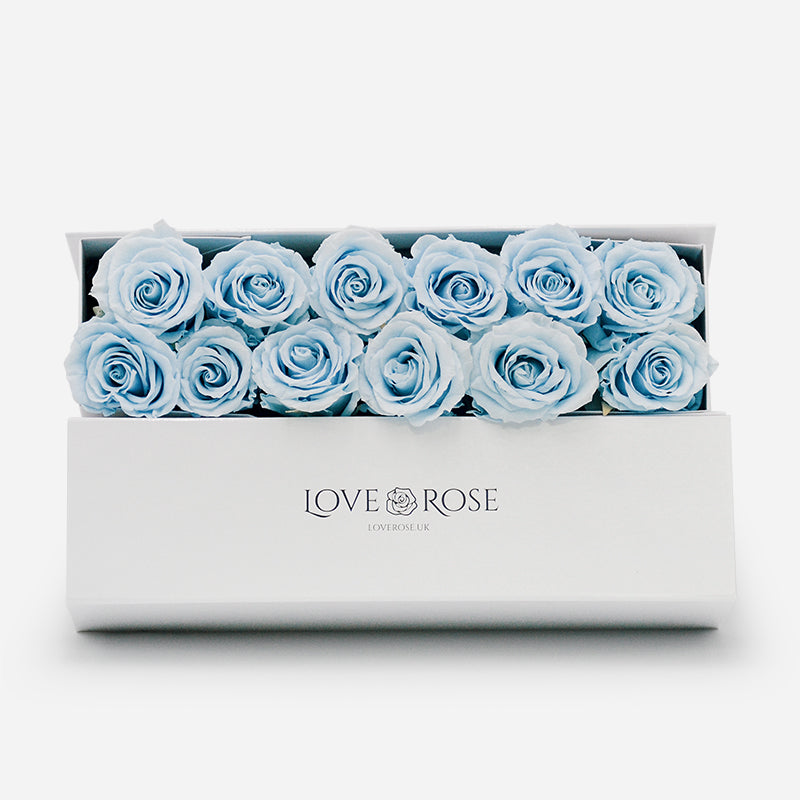 White luxury box of 12 blue forever roses.