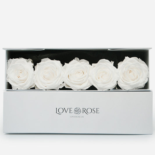 5 luxury white forever roses arranged in a luxury box