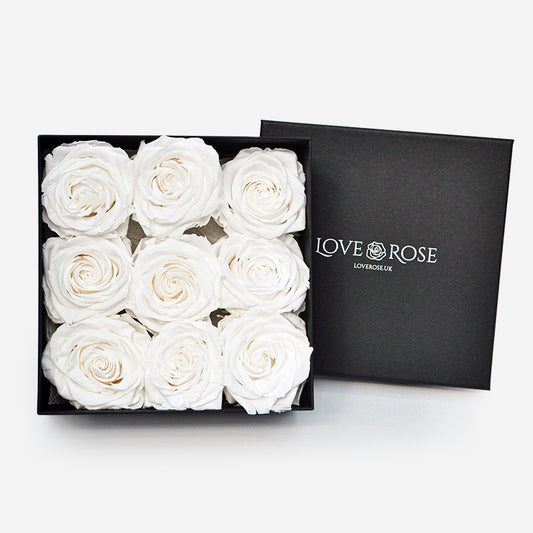 9 luxury white forever roses arranged in a black box