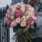 avalanche rose bouquet in the hands of a girl